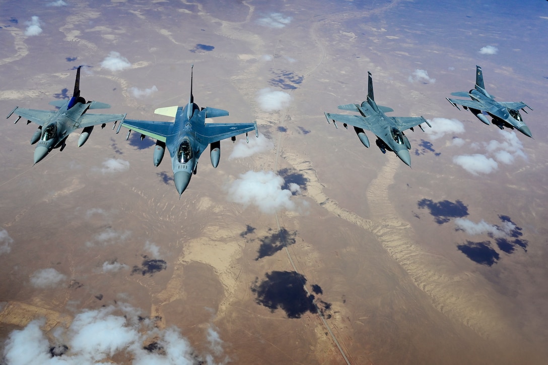Four F-16 Fighting Falcons fly in formation.