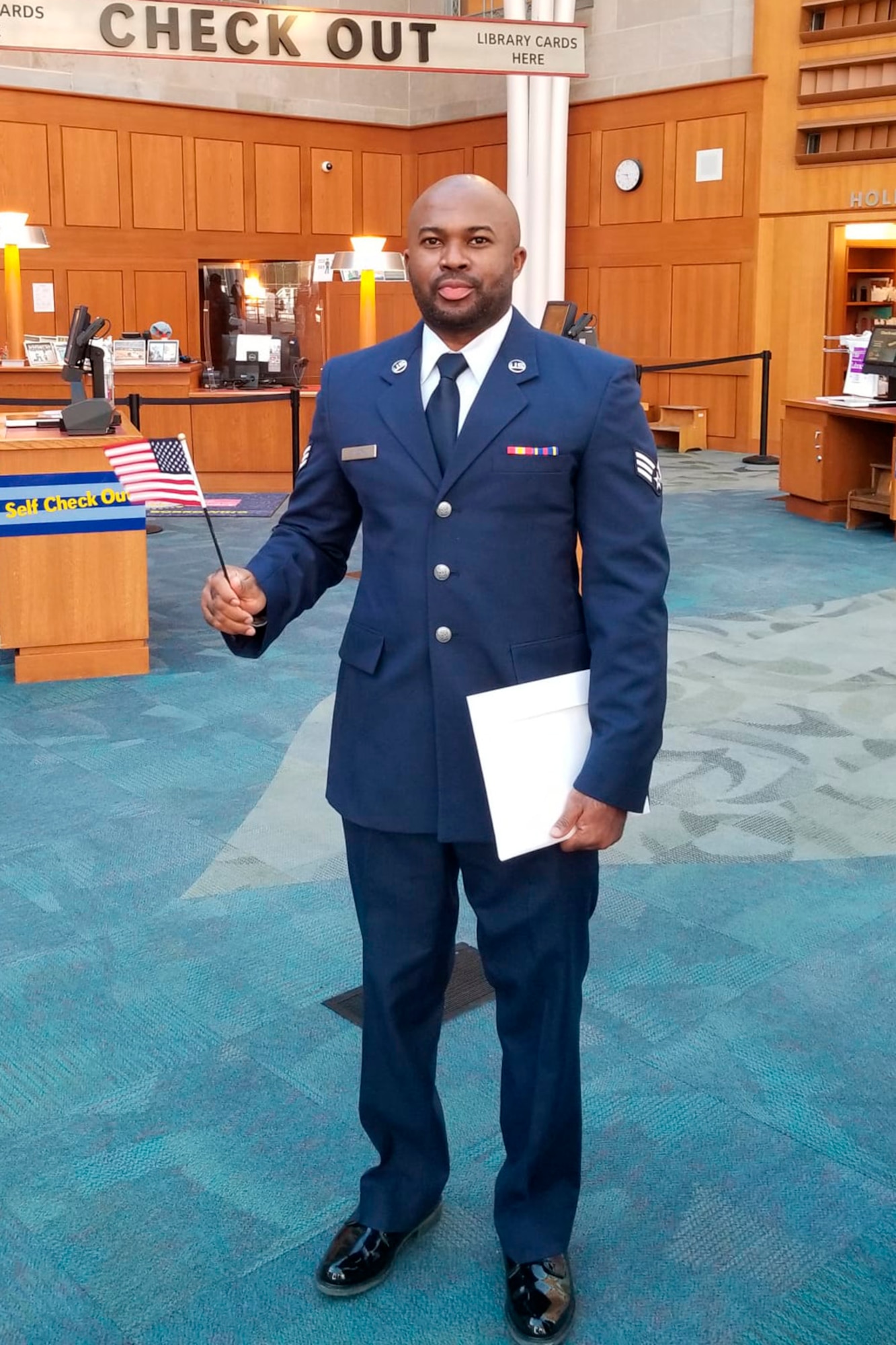Senior Airman Gentle Onuora, 434th Civil Engineer Squadron, pest management specialist poses for a photo with an American flag after officially becoming a United States citizen. Born in Nigeria, Onuora moved to the United States in 2015. On October 13, 2021 he obtained U.S. citizenship through his military service. (Courtesy photo/SrA Onuora)