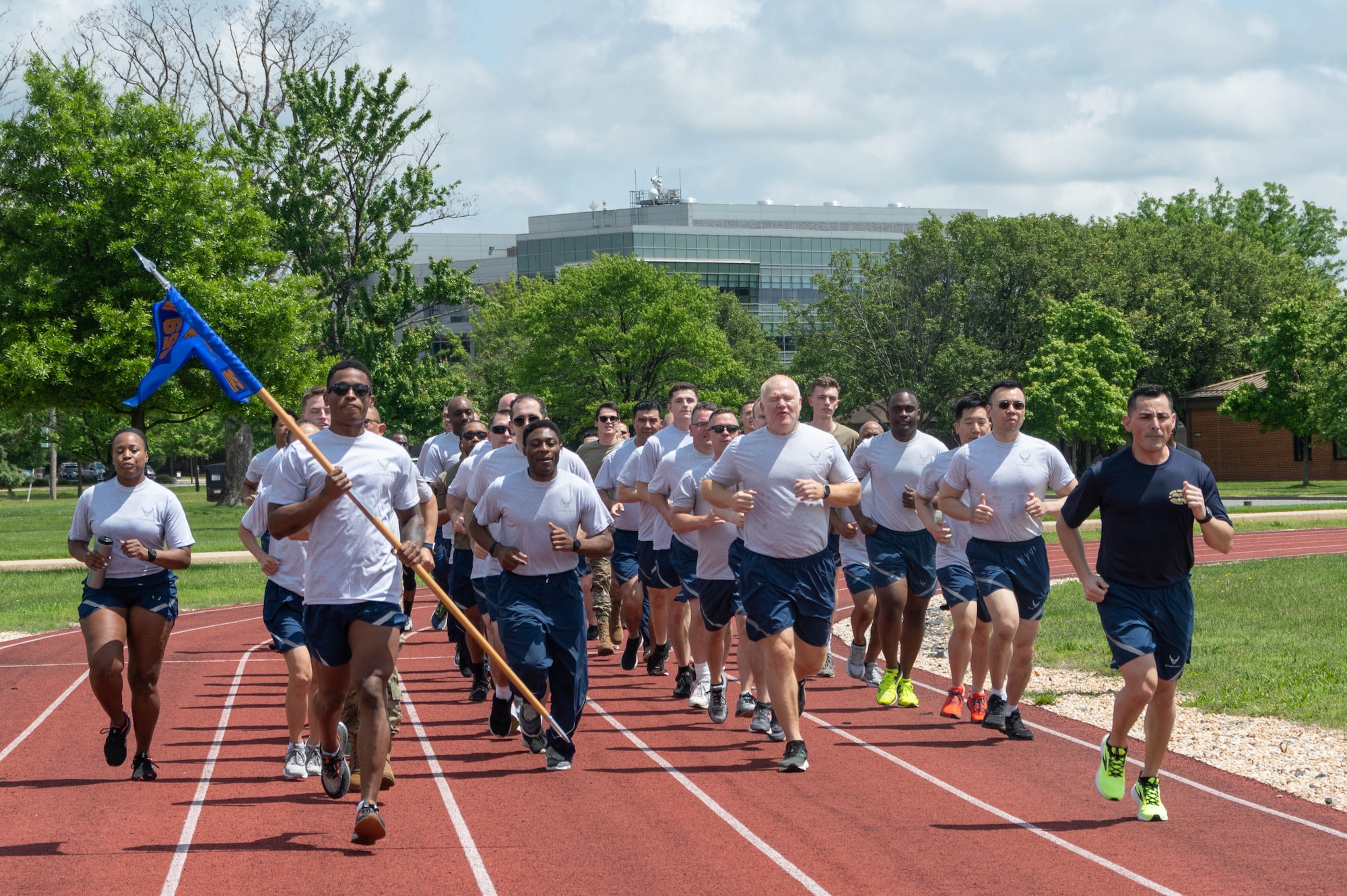 Airmen from the 69th Aerial Port Squadron run in formation at Joint Base Andrews, Md., May 15, 2022, as a part of the annual Port Dawg Memorial Run. The run, which began at Kadena Air Base, Japan, in 2013, honors Air Transportation Airmen who lost their lives over the past year. Seven aerial port Airmen died last year. Members in the career field say "they are 'blocked out,' but not forgotten." (U.S. Air Force Photo by Staff Sgt. Andreaa Phillips)