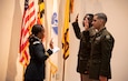Maj. Melisa Natapraya administers the oath of office to new 2nd Lts. David Aidoo and Ernesto Gonzalez during a commissioning ceremony May 20 at Hood College in Frederick, Maryland.