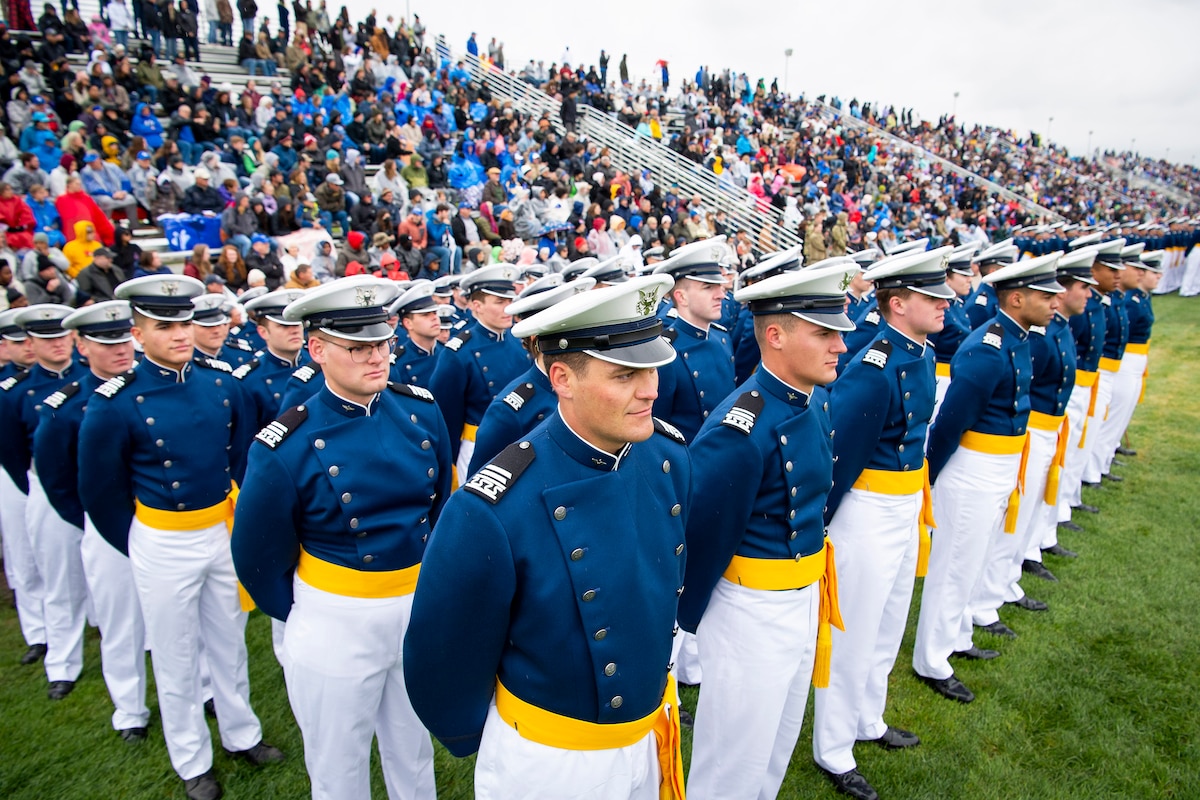 Cadets stand at parade rest during a ceremony.