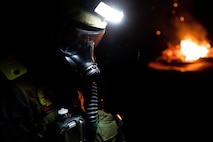 A U.S. Marine with Alpha Company, Chemical Biological Incident Response Force (CBIRF), patrols a simulated nuclear detonation training area collapsed building for notional casualties during Scarlet Response 2022 at Guardian Centers of Georgia, Georgia, May 19, 2022. CBIRFs initial response forces will deploy Marines to locate and extract casualties from the contaminated area and escort them to decontamination tents for further medical care. Scarlet Response 2022 is designed to physically and mentally test CBIRF personnel and the unit’s joint partners, the 911th Technical Rescue Engineer Company, in a simulated joint disaster response. (U.S. Marine Corps photo by Sgt. Kealii De Los Santos)
