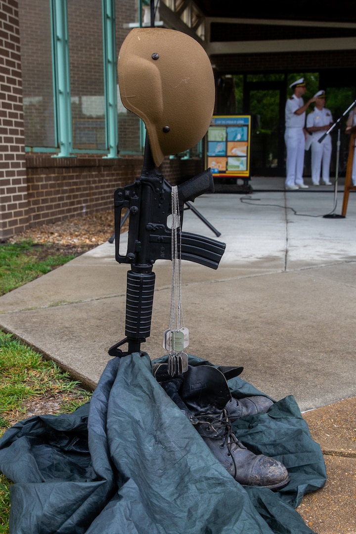 Members of the Norfolk Naval Shipyard Veterans Employee Readiness Group crafted a symbolic Battlefield Cross out of personal effects of shipyard veterans to represent their fallen brothers and sisters during the Memorial Day Fall-In for Colors May 25.