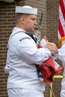 The Norfolk Naval Shipyard Flag Detail, alongside Gold Star Family Member and Veterans Employee Readiness Group member Glenn Branchaud, raises the flag during the Memorial Day Fall-In for Colors May 25.
