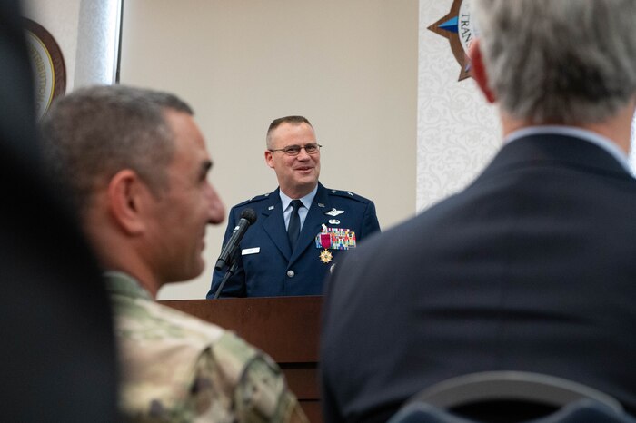 A person addresses the crowd during a change of command ceremony.