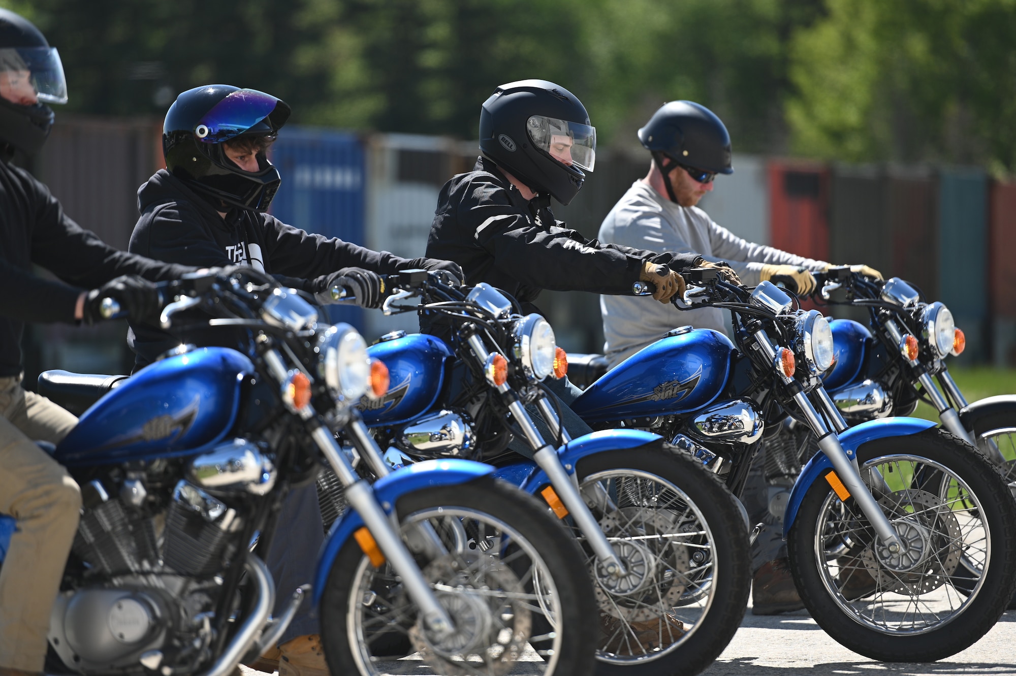 Motorcyclists line up on bikes.