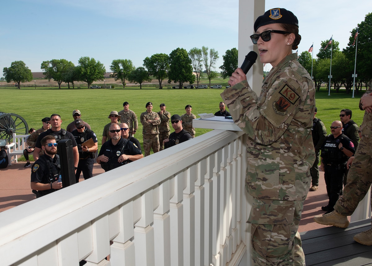 female Airman speaking to audience of law enforcement members