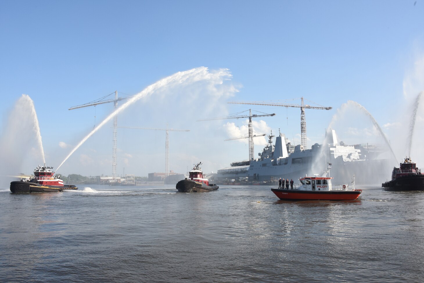 Tugboats jettison water into the air during a ‘water salute’ held in honor of National Maritime Day in downtown Norfolk, Virginia, May 19.