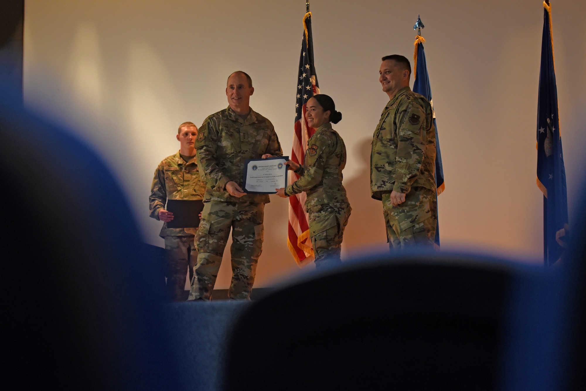 U.S. Air Force Lt. Gen. Kirk S. Pierce, Lt. Gen. Kirk S. Pierce, commander of Continental U.S. North American Aerospace Defense Command Region and 1st Air Force (Air Forces Northern and Air Forces Space), presents the Distinguished Graduate award to Airman 1st Class Maria Garcia, 315th Training Squadron student, during the 315th TRS’s intelligence, surveillance, and reconnaissance professionals’ graduation ceremony, at Goodfellow Air Force Base, Texas, May 24, 2022. Garcia was recognized for her outstanding academic achievement during her training. (U.S. Air Force photo by Senior Airman Abbey Rieves)