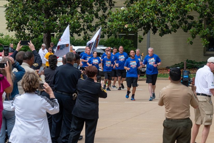 Athletes run in formation.