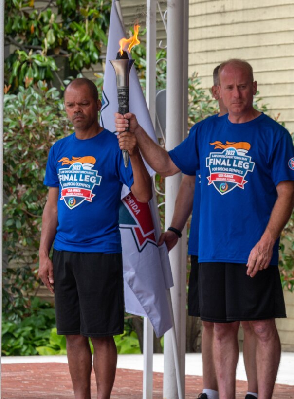 Men hold a torch.