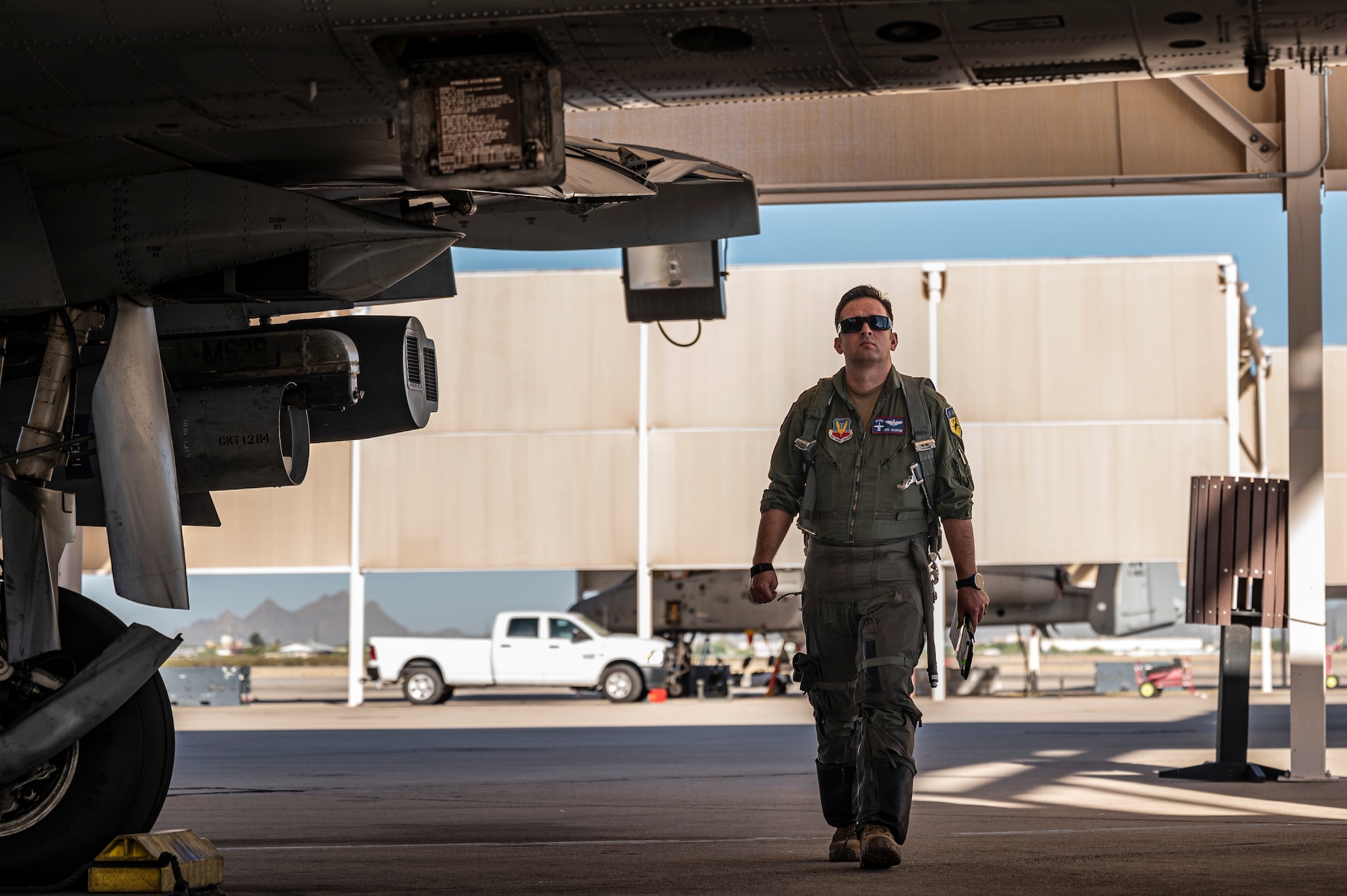 A photo of a pilot walking around the aircraft.