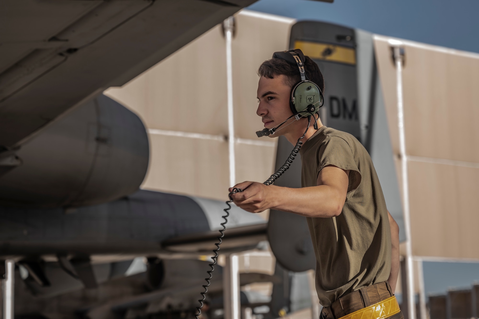 A photo of a maintainer performing preflight checks.