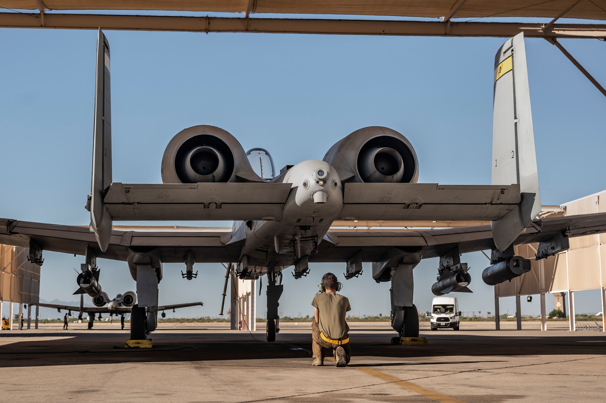 A photo of a maintainer performing preflight checks.