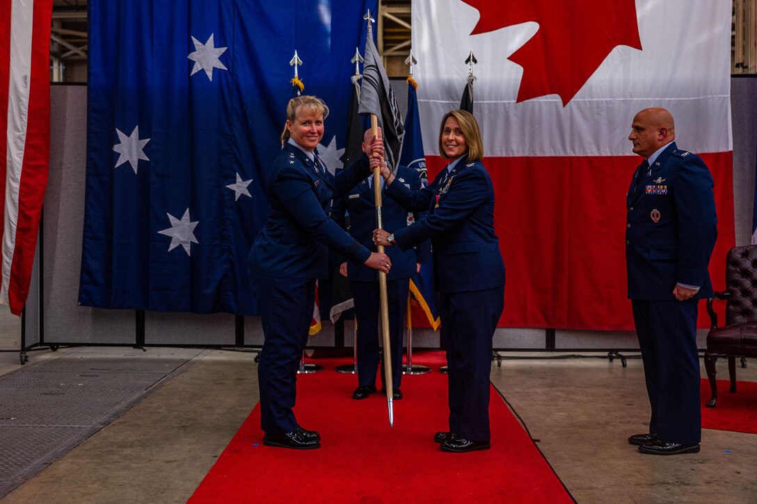 U.S. Space Force Maj. Gen. DeAnna Burt, left, Combined Force Space Component Command (CFSCC) commander and Space Operations Command (SpOC) vice commander, holds the Space Delta 5 guidon with U.S. Space Force Col. Monique DeLauter, previous Space Delta 5 (DEL 5) commander and Combined Space Operations Center (CSpOC) director, during the DEL 5 change of command ceremony at Vandenberg Space Force Base, Calif., May 24, 2022. The ceremonial exchanging of the guidon signifies DeLauter’s relinquishing her command of DEL 5 over to Burt and transferring the responsibility to U.S. Space Force Col. Phillip Verroco, the new Space DEL 5 commander and CSpOC director. (U.S. Space Force photo by Tech. Sgt. Luke Kitterman)