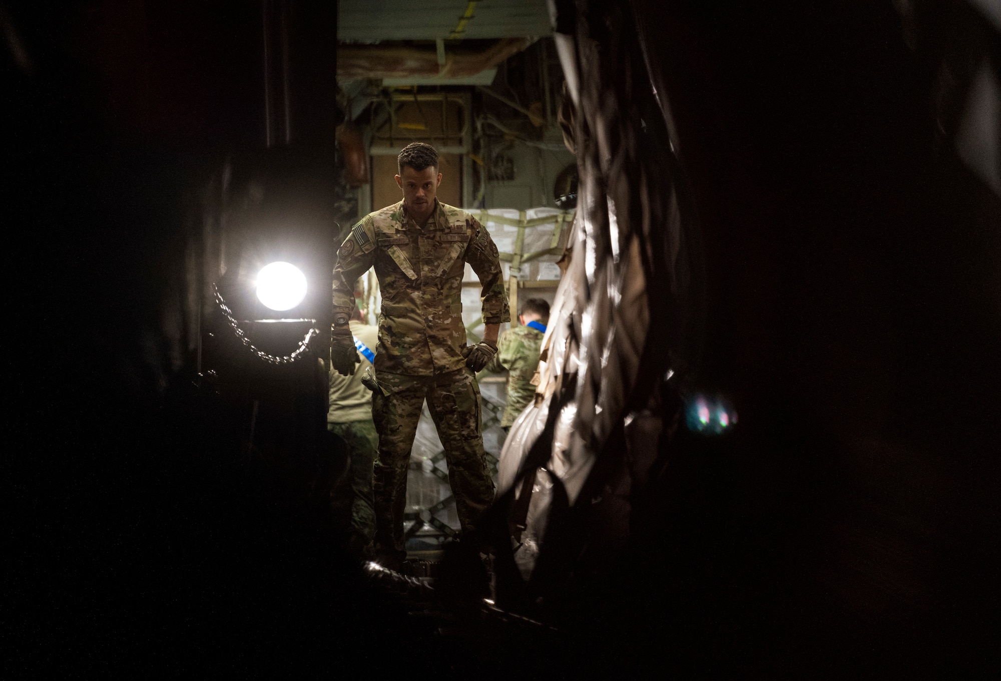U.S. Air Force Staff Sgt. Austin Simmons, loadmaster assigned to Joint Base Pearl Harbor-Hickam, Hawaii, helps transport pallets of infant formula onto a C-17 Globemaster III aircraft during Operation Fly Formula at Ramstein Air Base, Germany, May 22, 2022. The President of the United States launched Operation Fly Formula to speed up the import of infant formula from Europe to the United States due to critical shortages there.  The formula will be transported to Plainfield, Indiana via a U.S. Air Force C-17 Globemaster III coordinated by U.S. Transportation Command and Air Mobility Command. (U.S. Air Force photo by Staff Sgt. Jacob Wongwai)