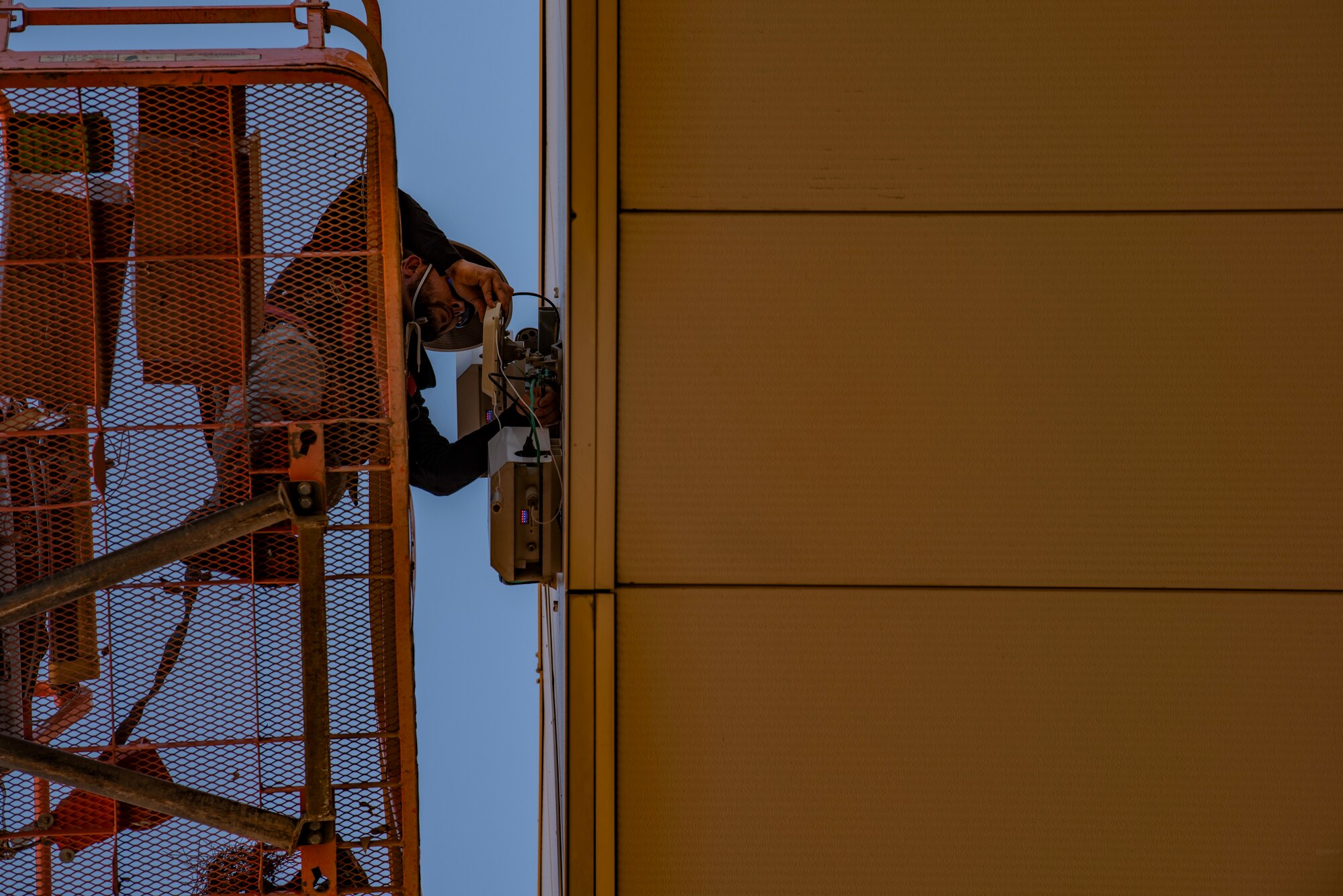 Clay Bossung, installation technician for By Light, installs Wi-Fi at Dyess Air Force Base, Texas, May 11, 2022. Dy-Fi will provide access to Non-Secure Internet Protocol to complete tasks for Airmen of both the 7th Bomb Wing and 317th Airlift Wing. (U.S. Air Force photo by Airman 1st Class Ryan Hayman)