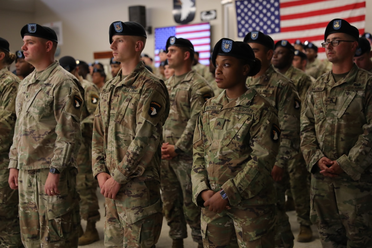 Service members stand in formation.