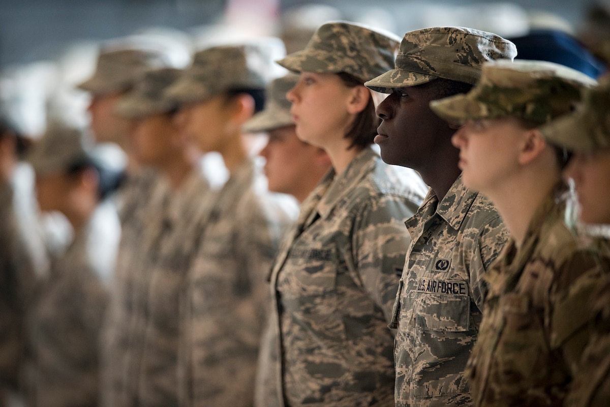 Service members stand in formation.