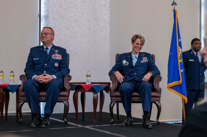 People laughing during a change of command ceremony.