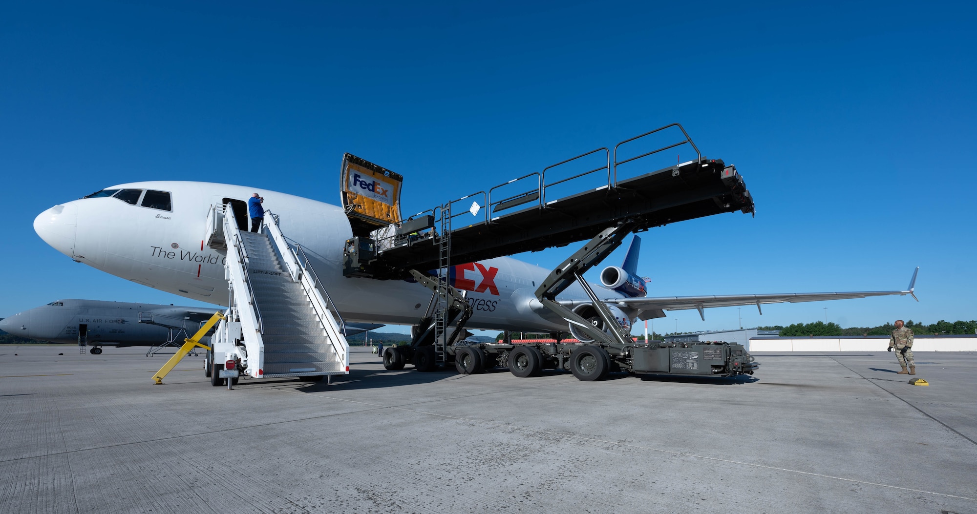 Pallets of infant formula are loaded onto a commercial aircraft.
