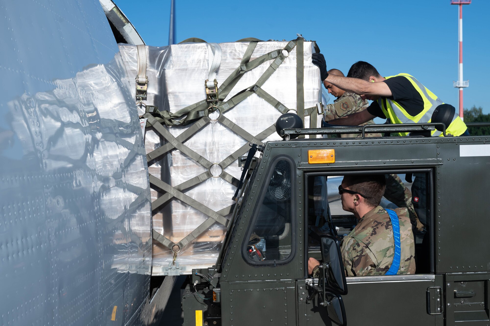 Port dawgs load pallets of infant formula onto a commercial aircraft.