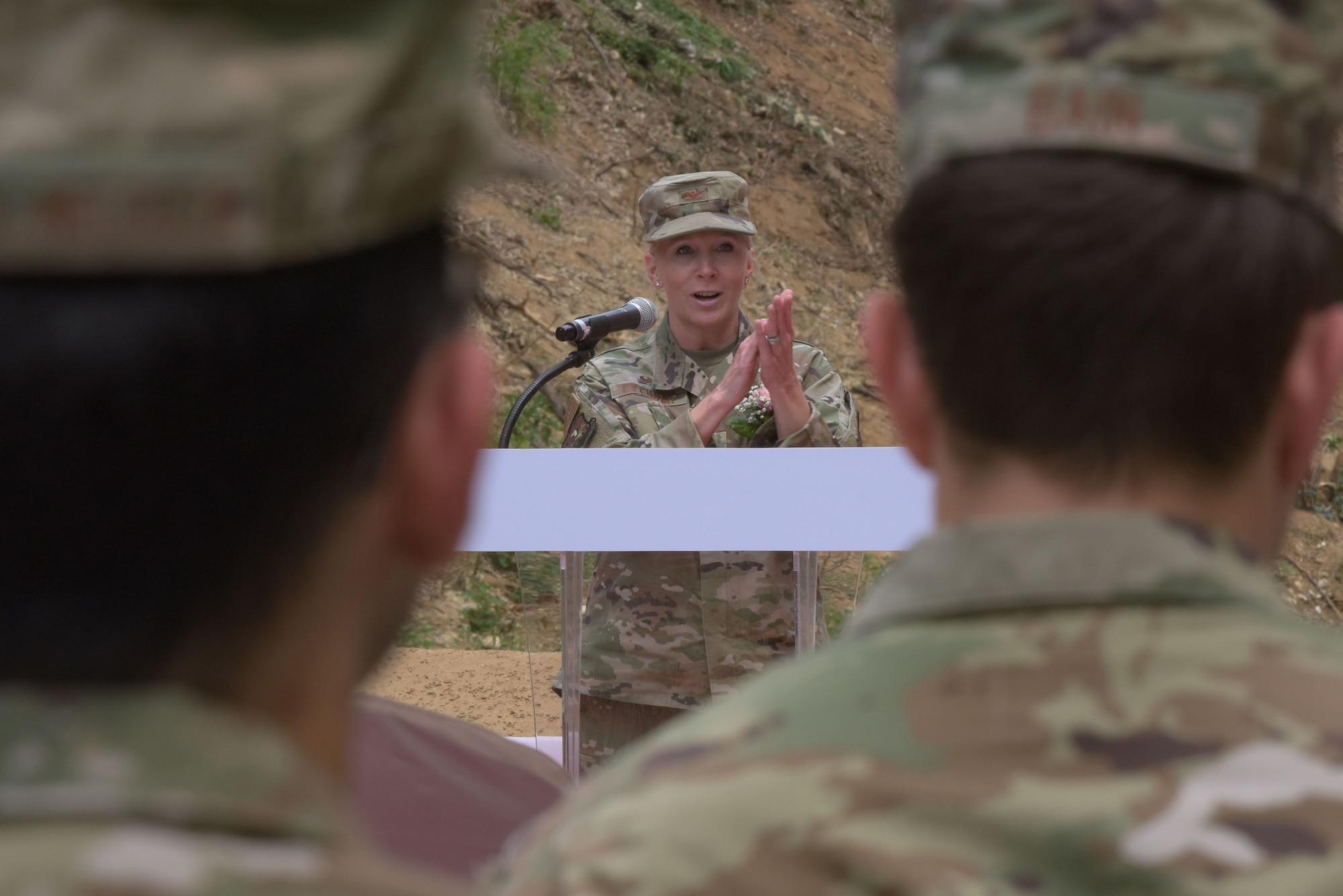 Col. Elizabeth Eychner, 51st Mission Support Group commander, applauds distinguished guests during the 51st Communications Squadron Headquarters Consolidation Facility Groundbreaking Ceremony at Osan Air Base, 25 May, 2022.