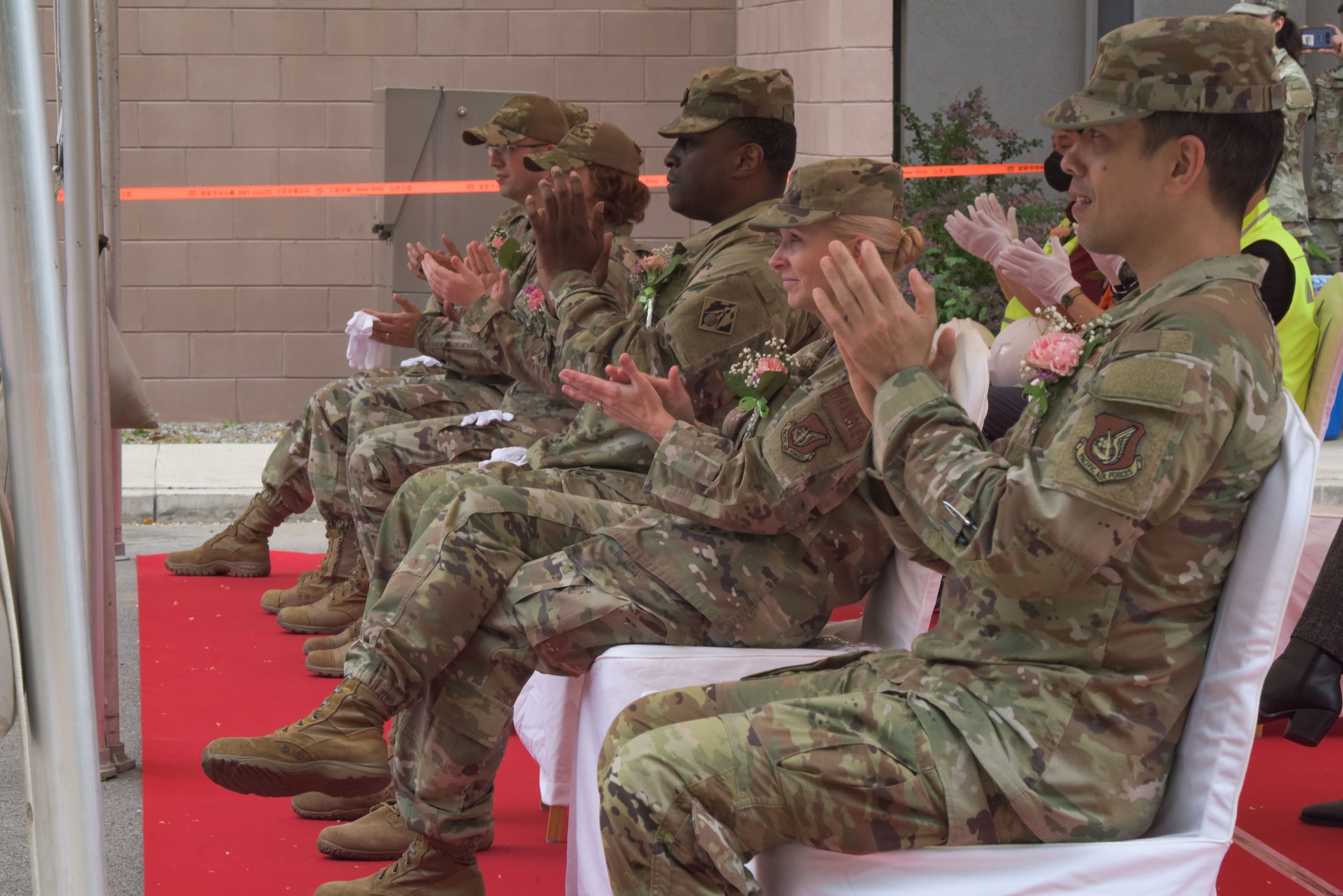 Distinguished guests applaud Lt. Col. Michael Williams, 51st Communications Squadron commander, after his speech during the 51st Communications Squadron Headquarters Consolidation Facility Groundbreaking Ceremony at Osan Air Base, 25 May, 2022.