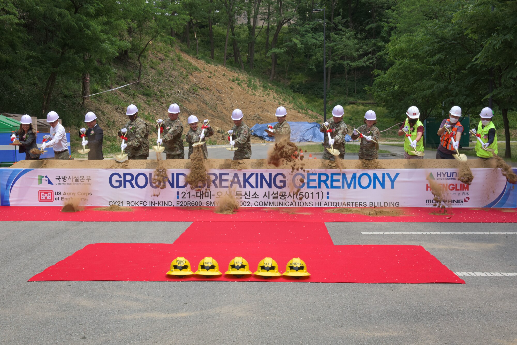 Leadership, civilians and Korean nationals shovel up the first mound of dirt at the construction site of the 51st Communications Squadron Headquarters Consolidation Facility Groundbreaking Ceremony at Osan Air Base, 25 May, 2022.