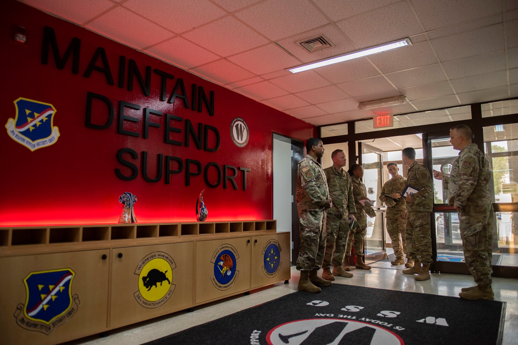 People stand near a doorway.