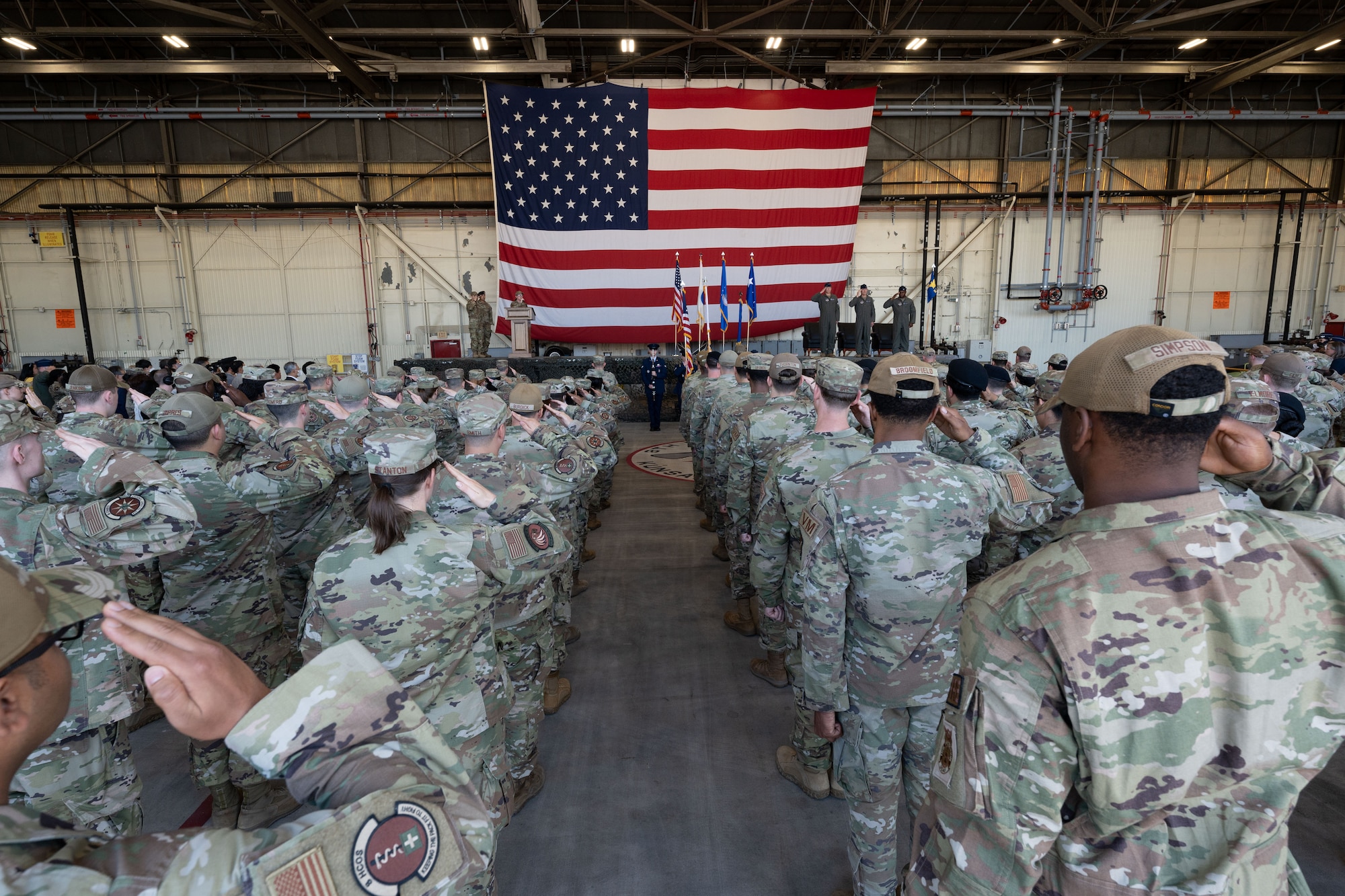 Wolf Pack Airmen salute the official party of the 8th Fighter Wing Change of Command ceremony at Kunsan Air Base, Republic of Korea, May 26, 2022. The change of command ceremony recognized the departure of Col. John B. Gallemore, outgoing 8th FW commander, and Col. Henry R. Jeffress, III, incoming 8th FW commander. (U.S. Air Force photo by Senior Airman Akeem K. Campbell)