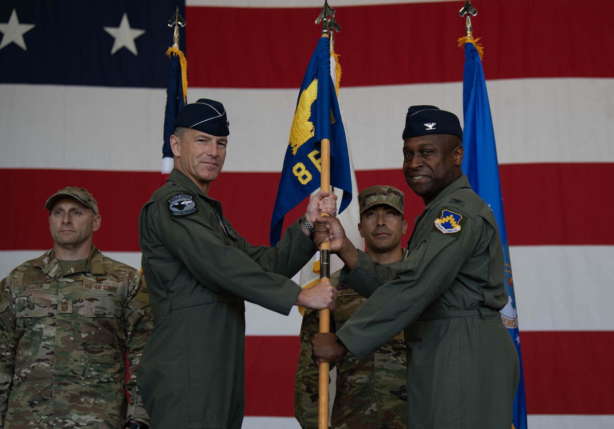 Lt. Gen. Scott Pleus, Seventh Air Force commander and presiding officer, presents the ceremonial guidon to Col. Henry R. Jeffress, III, incoming 8th Fighter Wing commander, during the wing change of command ceremony at Kunsan Air Base, Republic of Korea, May 26, 2022. Jeffress, or Wolf 62, assumed command of the 8th FW from the outgoing commander, Col. John B. Gallemore. (U.S. Air Force Photo by Senior Airman Shannon Braaten)