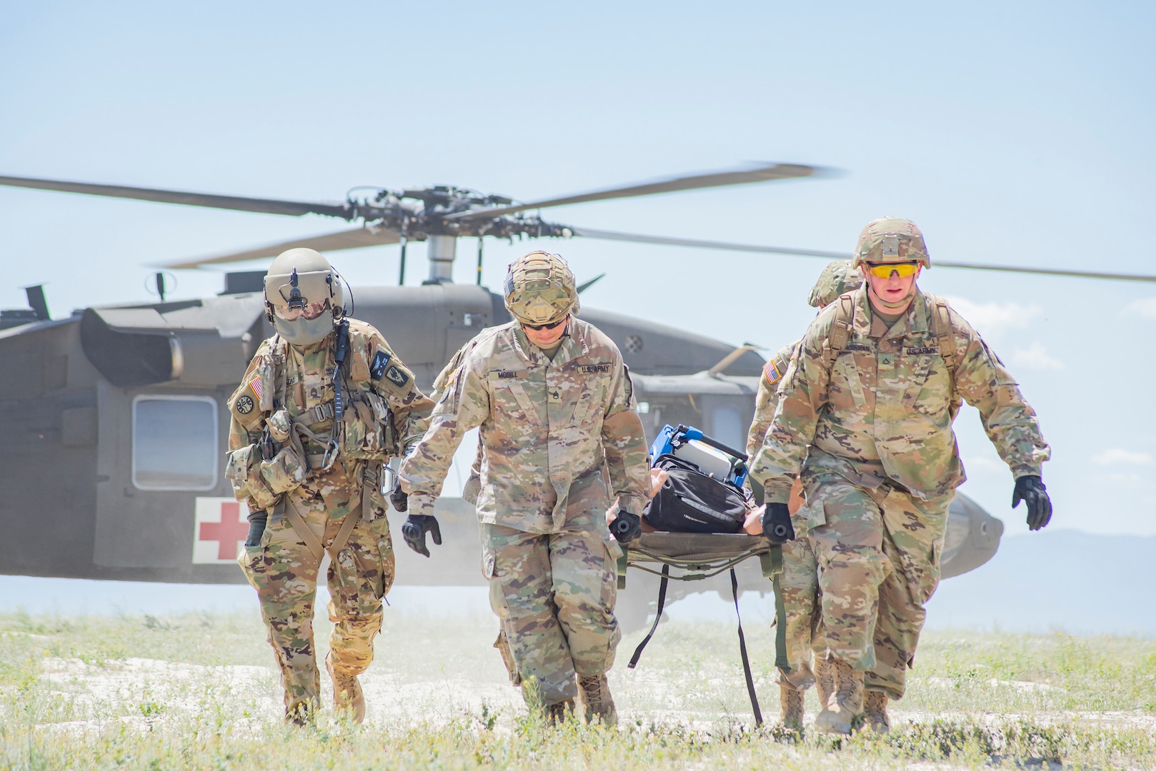 Members of the Idaho Army National Guard’s Headquarters and Headquarters Battery, 1st of the 148th Field Artillery Regiment, conduct air medical evacuation and casualty treatment with members of Detachment 1, Company Golf, 1st of the 168th General Support Aviation Battalion, at the Orchard Combat Training Center May 17, 2022.