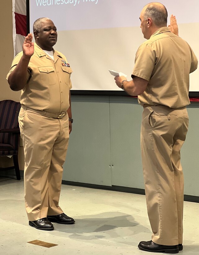IMAGE: Naval Surface Warfare Center Dahlgren Division Commanding Officer Capt. Philip Mlynarski swears-in newly promoted Master Chief Petty Officer Justin Preyer during a Naval frocking ceremony on May 25 at Mayport Navy Base in Jacksonville, Florida.