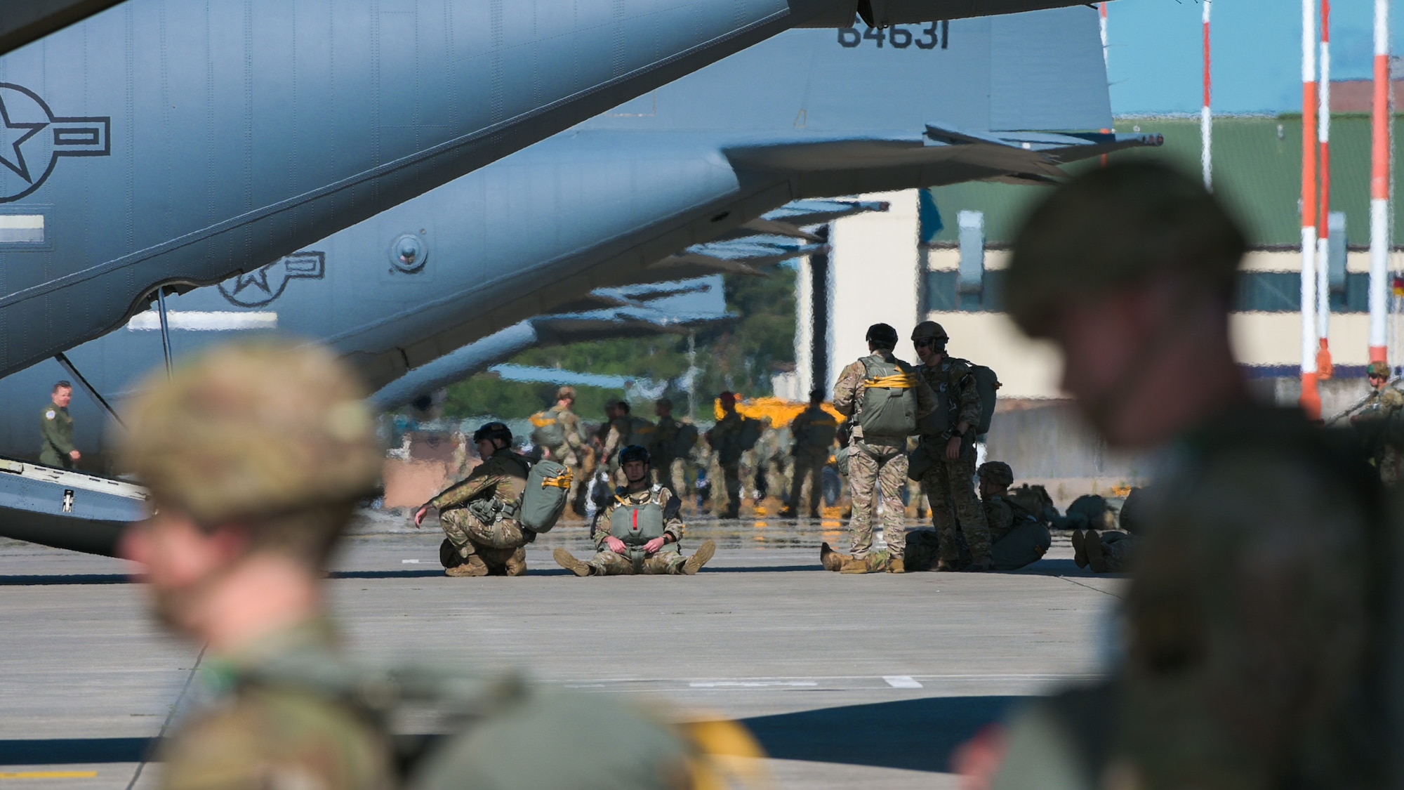 Eighty U.S. Army paratroopers load into nine C-130J Super Hercules aircraft
