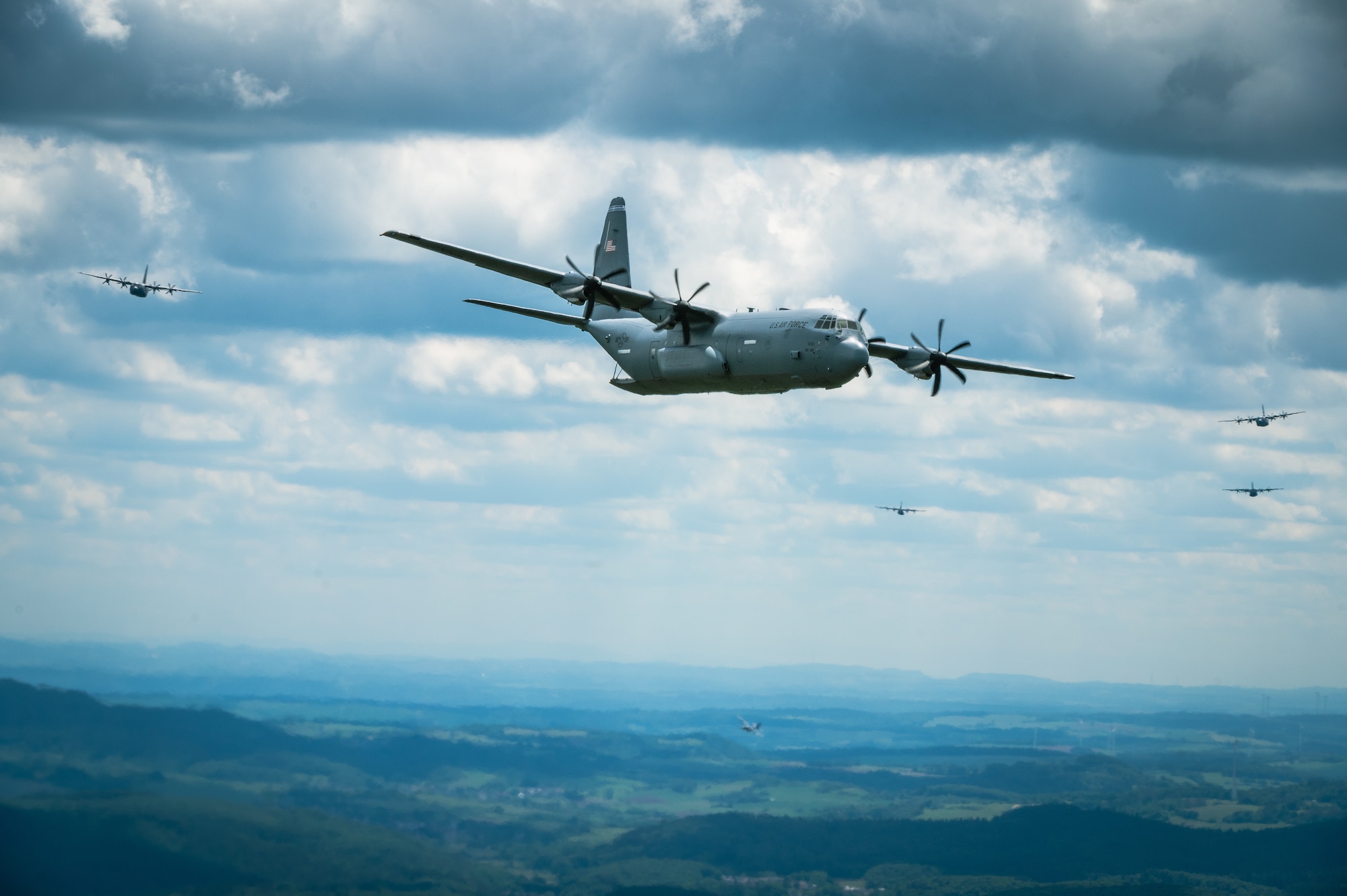 Nine C-130J Super Hercules fly in formation