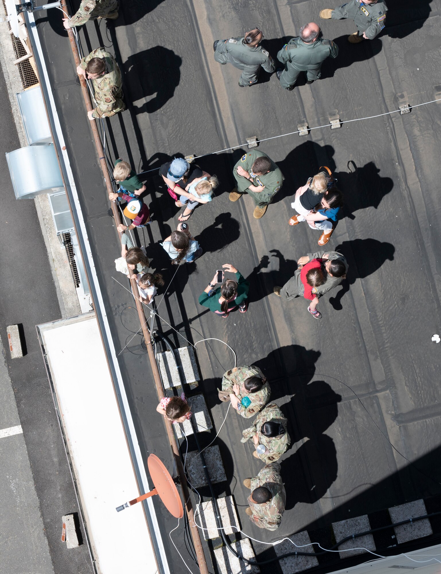 Military, family and friends watch as nine C-130J Super Hercules aircraft