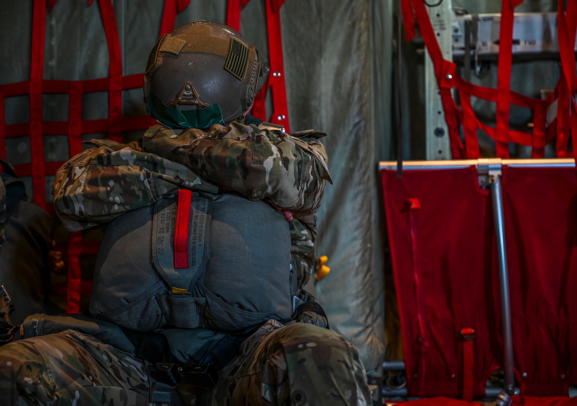 A U.S. Army Soldier from the 1st Battalion, 10th Special Forces Group from Stuttgart, Germany, rests before jumping out of a C-130J Super Hercules