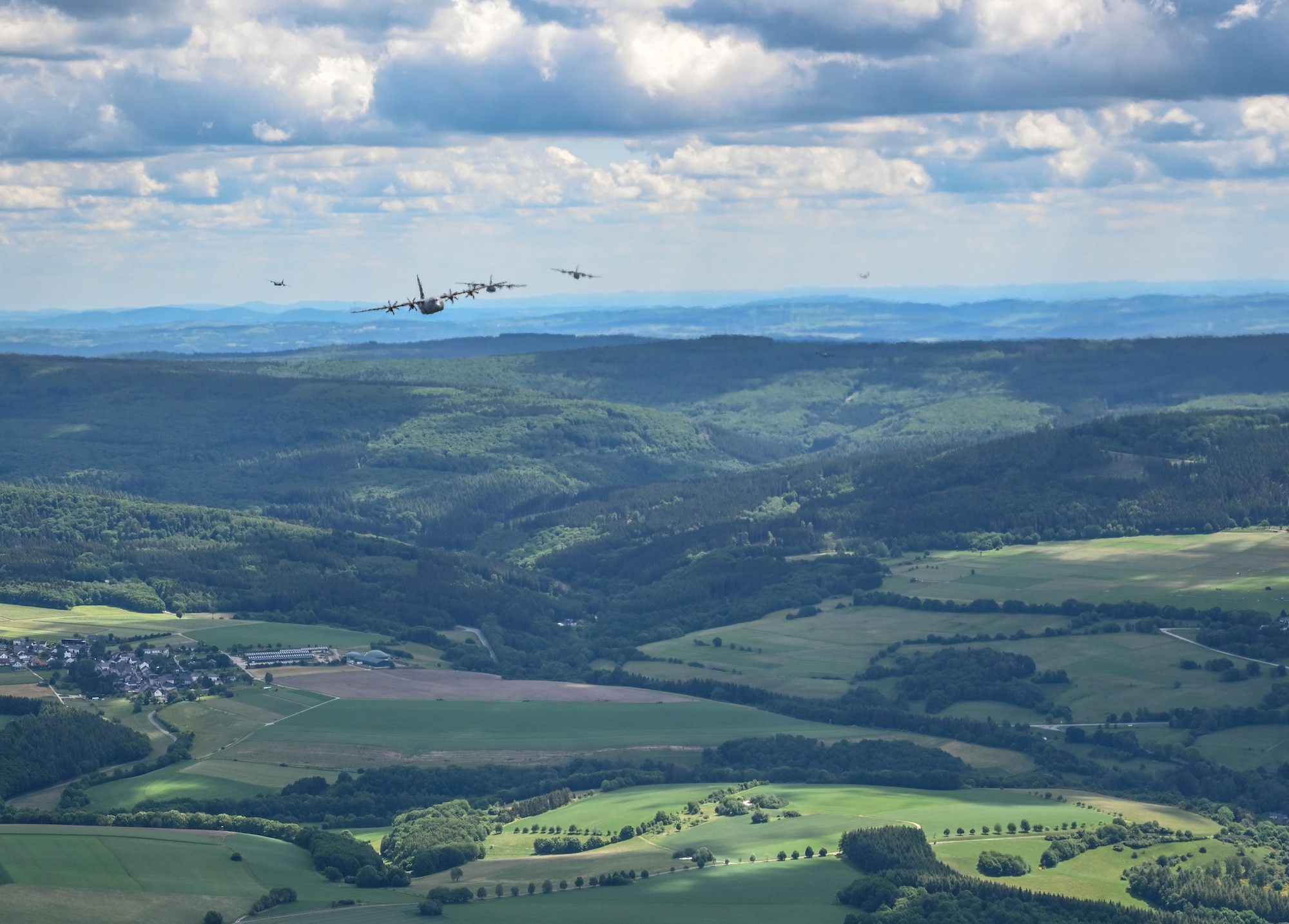 Six C-130J Super Hercules aircraft, assigned to the 37th Airlift Squadron, fly in a large formation