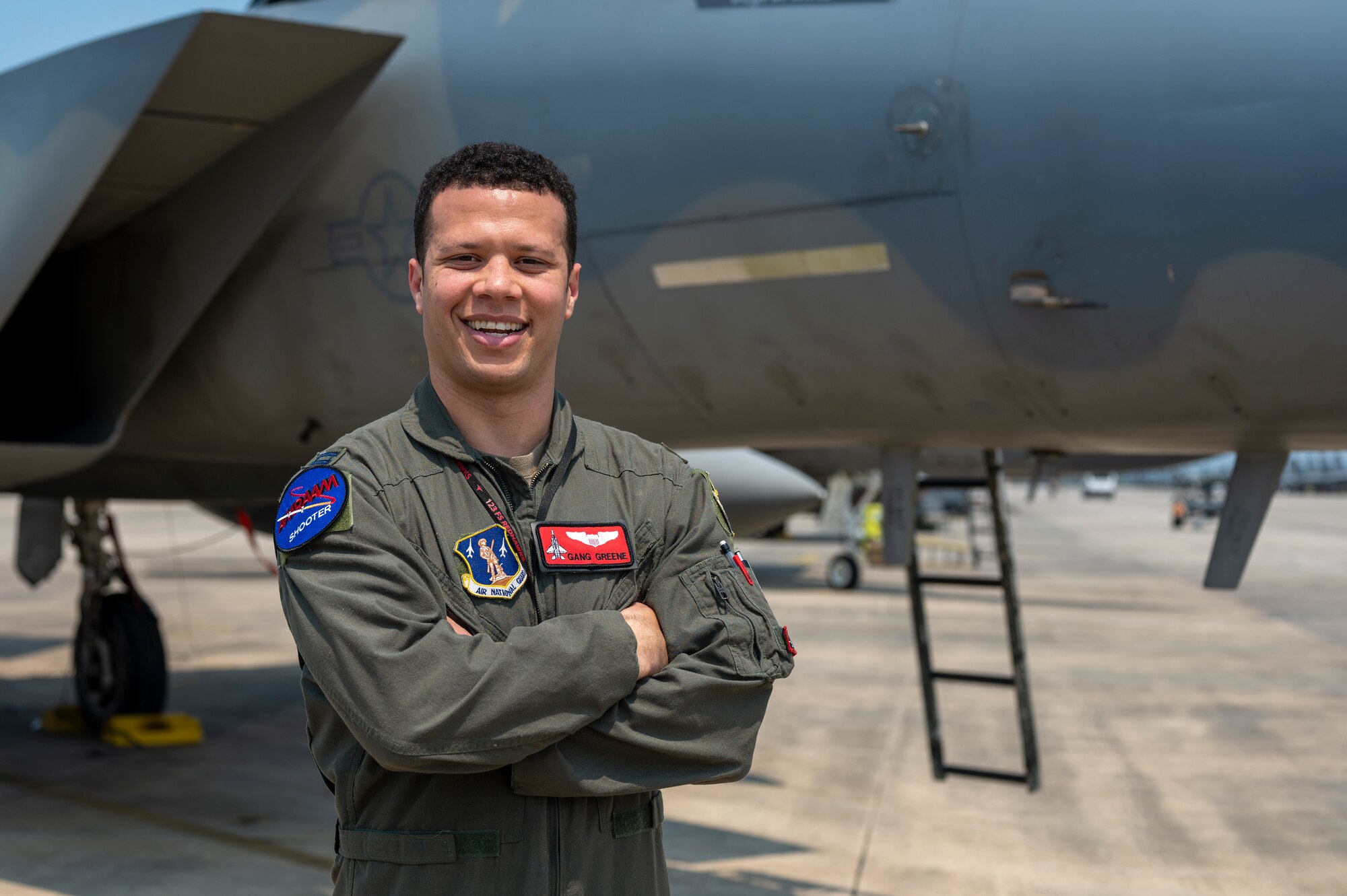 Airman stands in front of jet