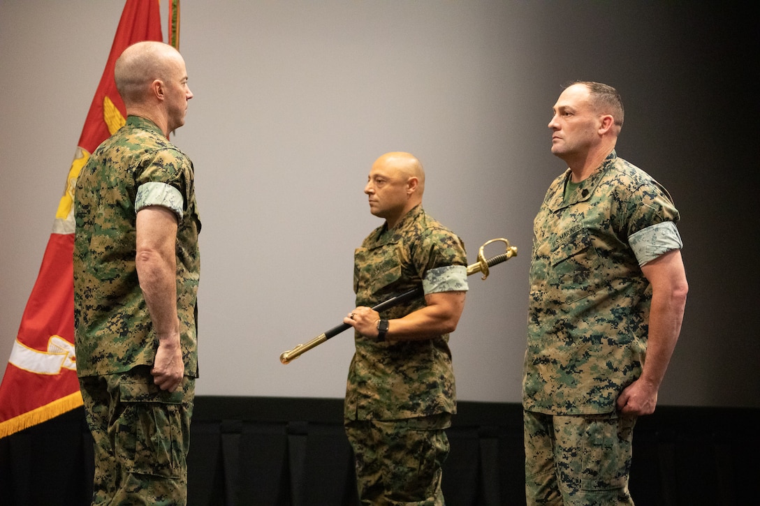 Marine Corps Logistics Base Albany officials held a post and relief ceremony, May 26, at the Base Theater.  Master Sgt. Jamil P. Alkattan, acting Base Sergeant Major Master relinquished his post by transferring the sword of office to incoming Base Sergeant Major Chad M. Coston.  Alkattan, who will be departing soon for Camp Pendleton, California, received the Meritorious Service Medal.