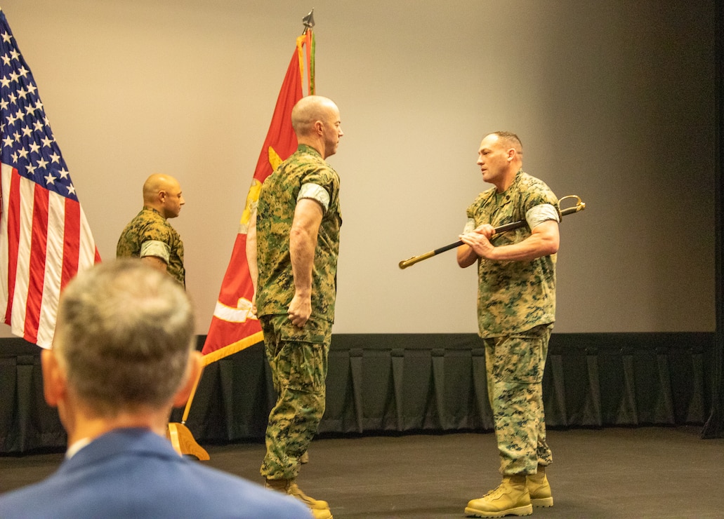 Marine Corps Logistics Base Albany officials held a post and relief ceremony, May 26, at the Base Theater.  Master Sgt. Jamil P. Alkattan, acting Base Sergeant Major Master relinquished his post by transferring the sword of office to incoming Base Sergeant Major Chad M. Coston.  Alkattan, who will be departing soon for Camp Pendleton, California, received the Meritorious Service Medal.