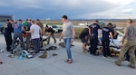 Oregon Air National Guard Airmen with the 125th Special Tactics Squadron work alongside paramedics to prepare two patients for transport near Boise, Idaho, May 15, 2022. After completing a day of small arms training, the Oregon Airmen were in a convoy heading to Gowen Field, Idaho, when they witnessed an accident that injured two people on a motorcycle.