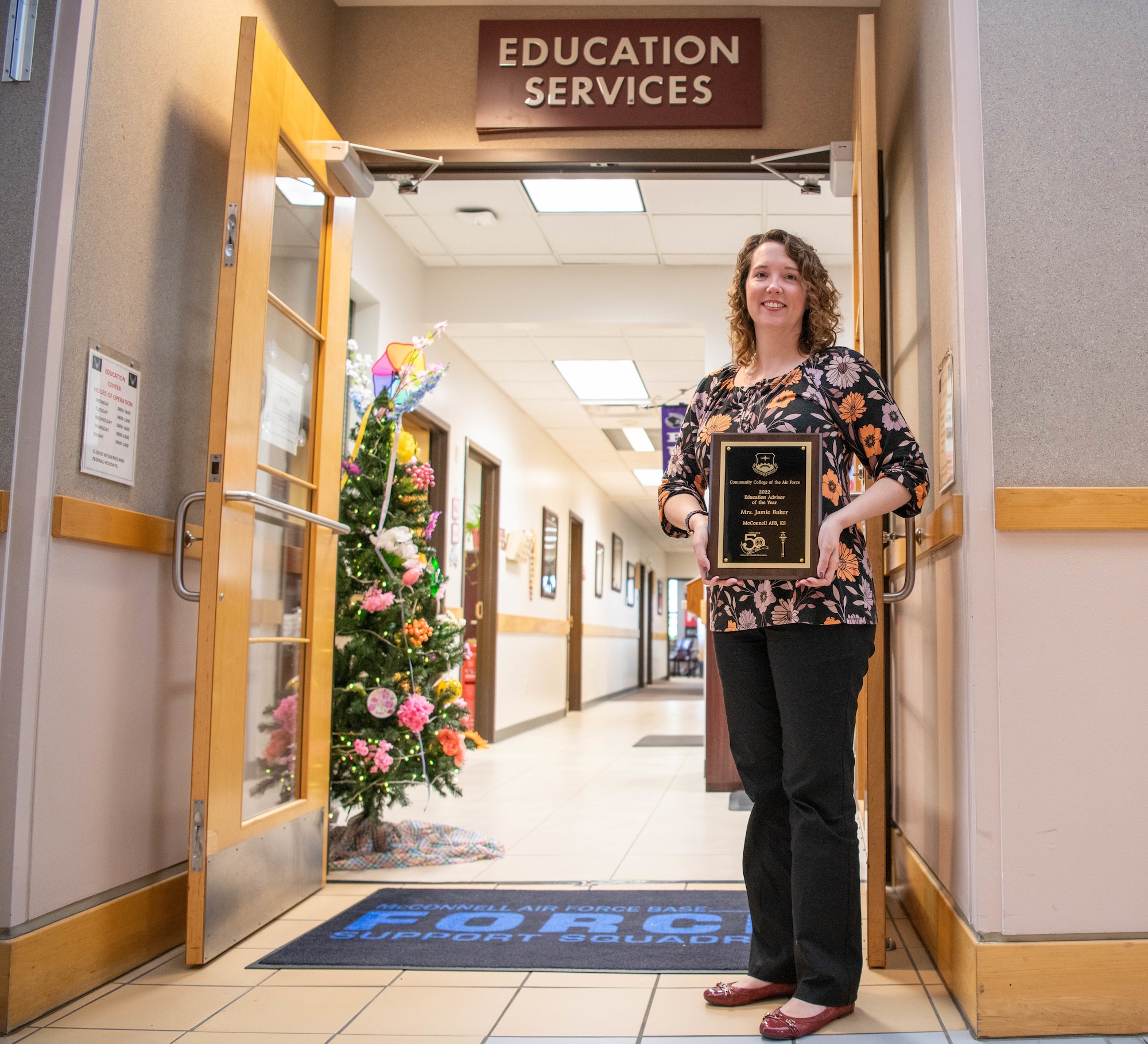 Jamie Baker, 22nd Air Refueling Wing Chief Education and training, poses for a photo with her Community College of the Air Force Advisor of the Year award outside of her office, April 26, 2022 at McConnell Air Force Base, Kanas.