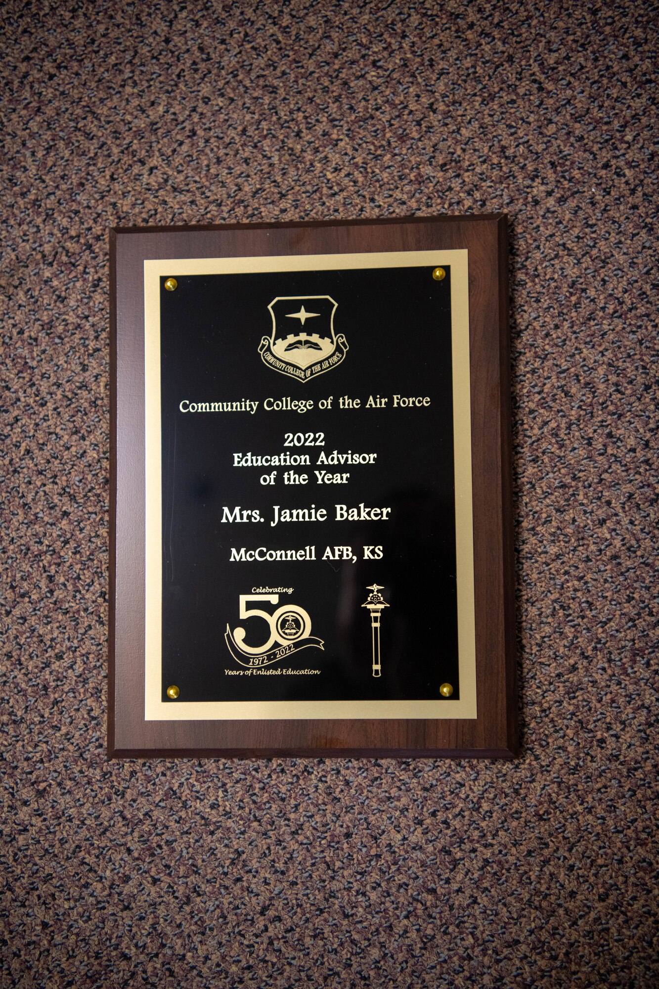 Jamie Baker, the Chief of Education and training for the 22nd Air Refueling Wing, received this plaque after being selected for the Community College of the Air Force Advisor of the Year, here it hangs in her office April 26, 2022 at McConnell Air Force Base, Kansas.