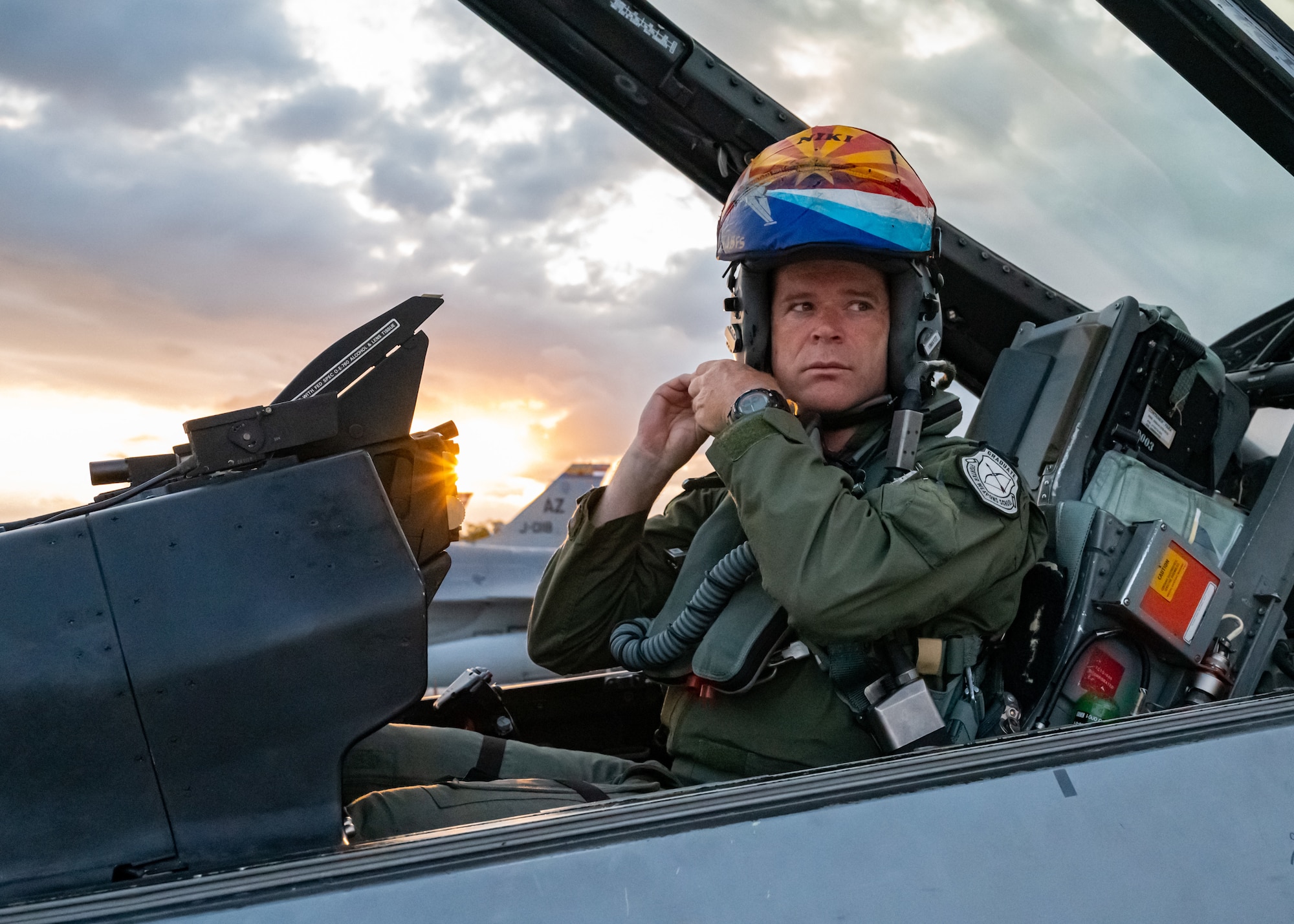 Lt. Col. Joost Luijsterburg, Royal Netherlands Air Force detachment commander, Morris Air National Guard Base, Ariz., buckles the chin strap of his helmet at Naval Air Station Key West, Fla. This is the last temporary duty that the RNLAF will make with the 162nd Wing before they return to the Netherlands. (U.S. Air National Guard photo by Tech. Sgt. George Keck)