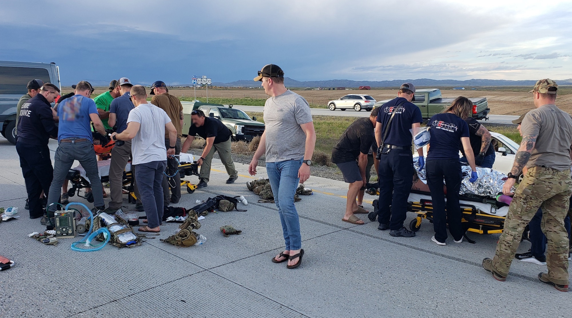 125th Special Tactics Squadron Airmen work alongside paramedics to prepare two patients for transport near Boise, Ida. on May 15, 2022. After completing a day of small arms training, these Oregon Air National Guard Airmen were in a convoy heading to Gowen Field, Ida. when an accident unfolded in front of them