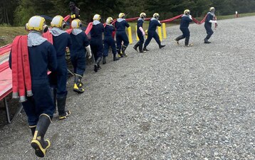 (May 26, 2022) WHIDBEY ISLAND, Wash. Firefighting students at the Center for Naval Aviation Technical Training Unit Whidbey Island retrieve some firehoses during their training. (U.S. Navy photo)