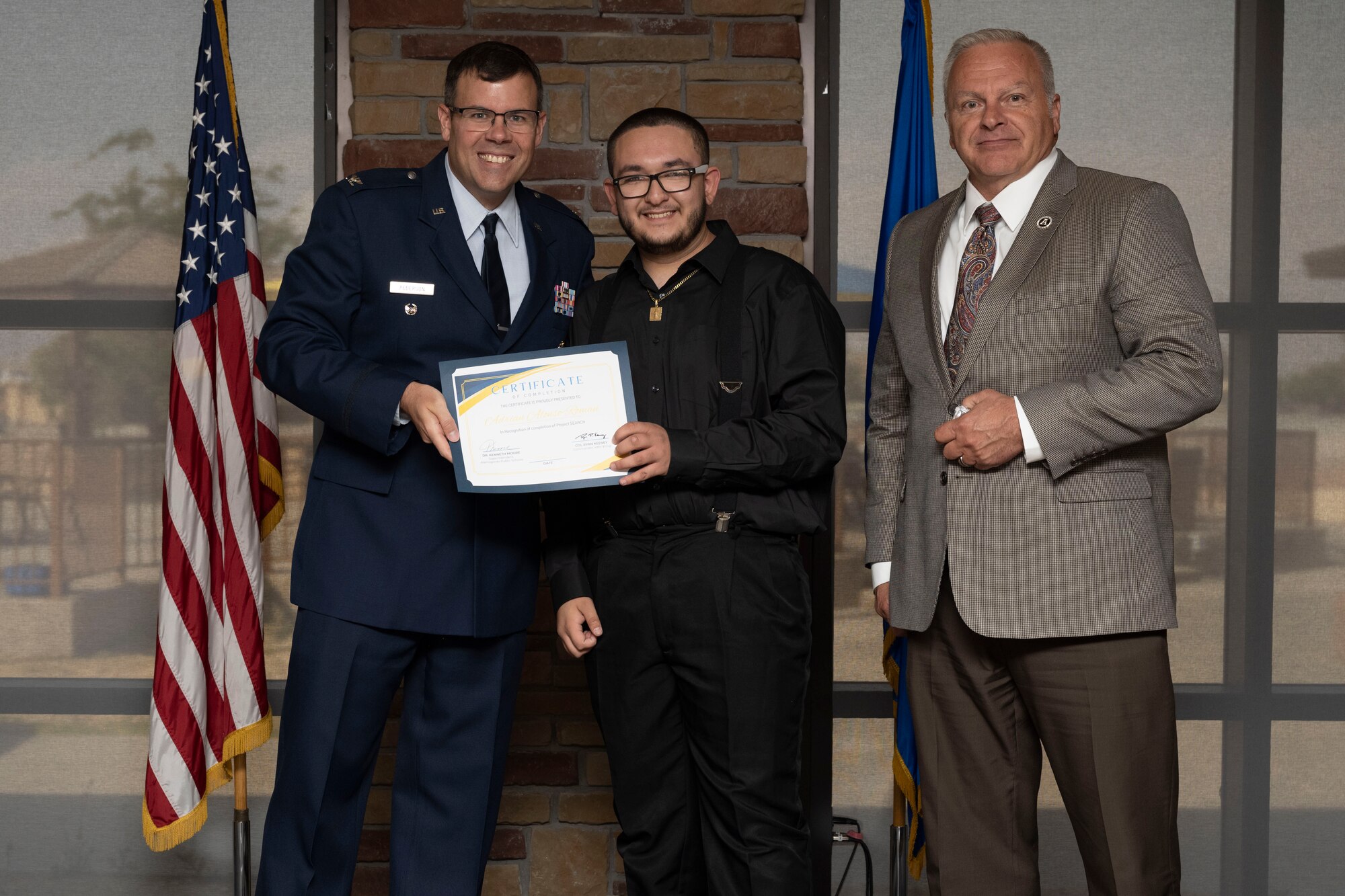 Adrian Alonson-Roman, Project SEARCH intern, receives graduation certificate, May 24, 2022, on Holloman Air Force Base, New Mexico.
