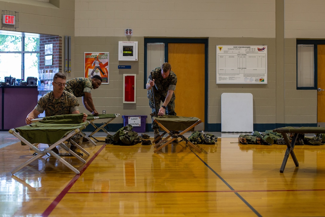 U.S. Marines assigned to Headquarters and Headquarters Squadron, Marine Corps Air Station (MCAS) Cherry Point, set up cots during HURREX in the gymnasium of the Cherry Treehouse, MCAS Cherry Point, North Carolina, May 16, 2022. HURREX is a week-long hurricane preparedness exercise held across the installation that’s intended to increase MCAS Cherry Point’s readiness for the Atlantic hurricane season. (U.S. Marine Corps photo by Lance Cpl. Lauralle Walker)